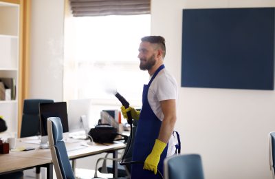 professional-cleaning-service-person-using-steam-cleaner-office
